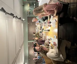 Guests dining at a table while tasting 6 different wines and taking notes