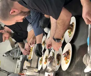 Line cooks busy at work in our kitchen