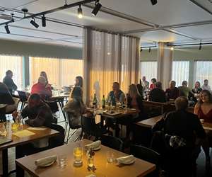 busy dining room full of people during sunset