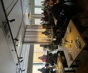 busy dining room full of people during sunset